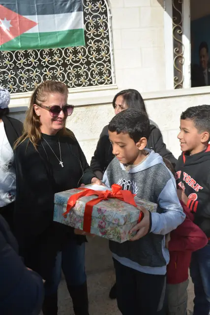 A child receiving a gift from the Marka team