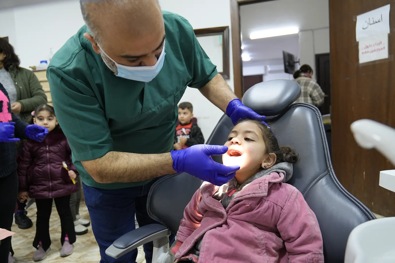 A dentist treating a young girl at the Marka clinic